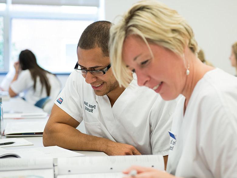 Two nursing students doing homework.