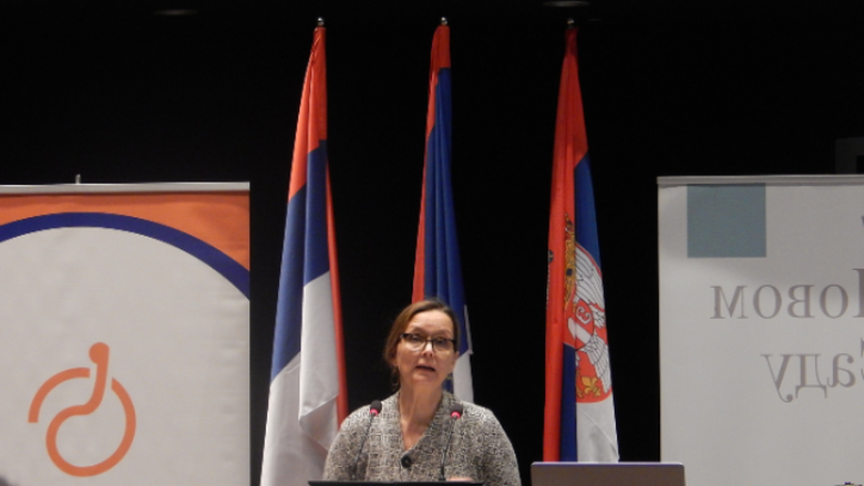 A woman standing behind a podium 